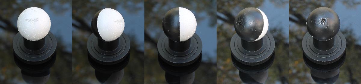 A styrofoam ball, painted half black and viewed from different angles, illustrates the phases of the moon.