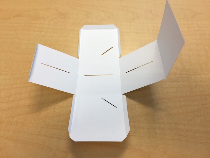 The folded exterior of a paper cube sundial