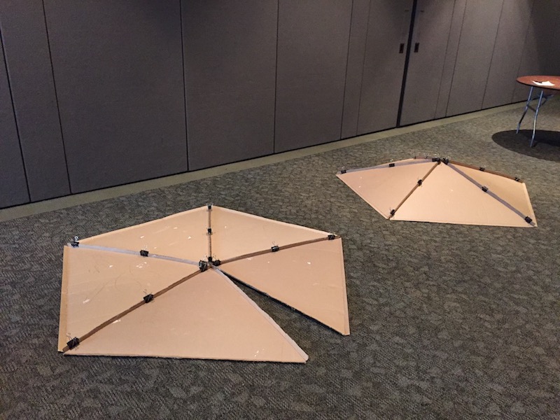 Assembling pentagonal portions of a cardboard geodesic dome