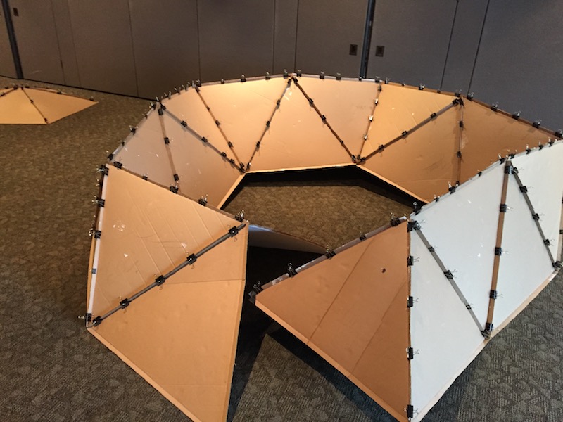 A partially assembled cardboard geodesic dome