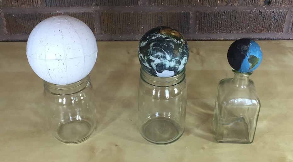 Three examples of homemade globes, including a celestial sphere, the earth with clouds, and a day/night earth, in various sizes