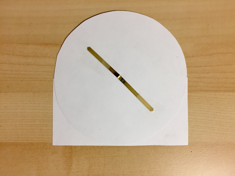 The back side of a paper lunar phase dial
