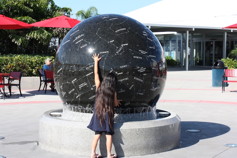 This little girl was playing with the Constellation Sphere. The ball weighs 9 tons, but floats on a fountain that makes it possible for a person to roll it.
