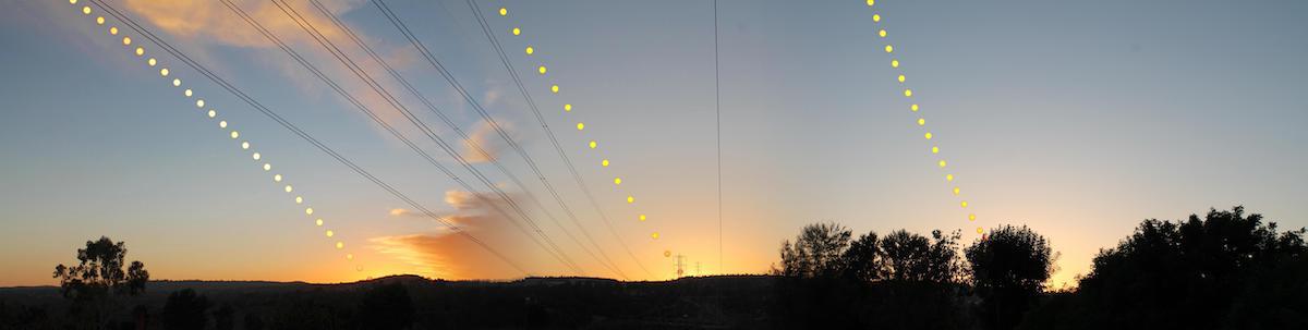 A composite panorama of three sunsets, showing the sun's path at the solstices and equinoxes