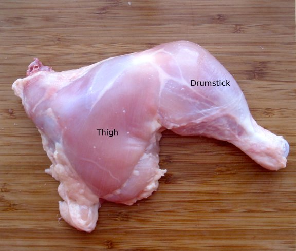 A chicken leg quarter with the skin removed, showing the musculature