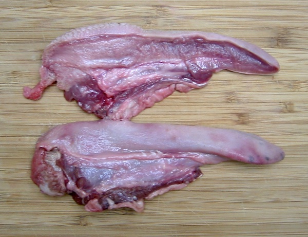 A lamb's tongue from a meat market, cut in half to reveal the internal structure